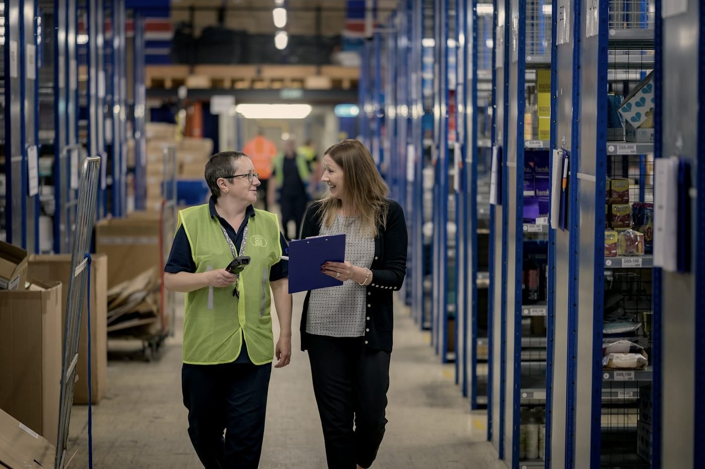 Two team members reviewing inventory together in a distribution warehouse